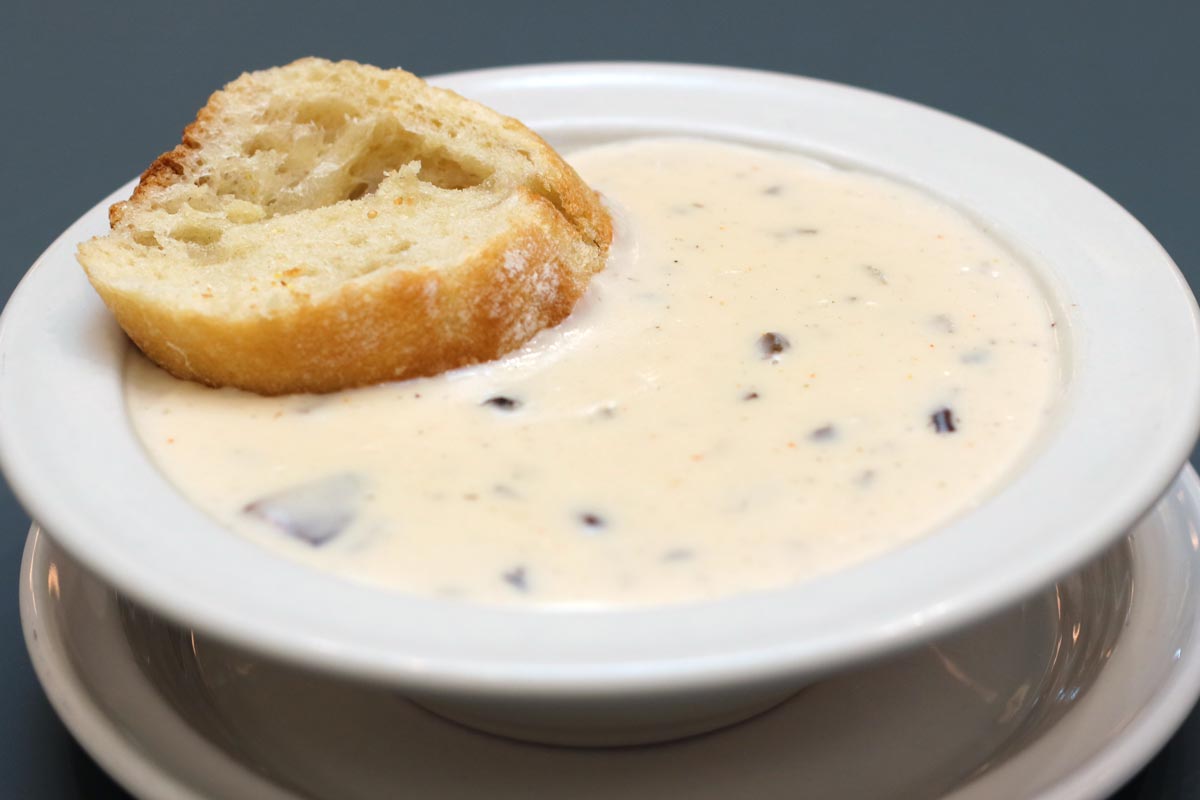 Cream of Mushroom Soup with a slice of bread on the side. 