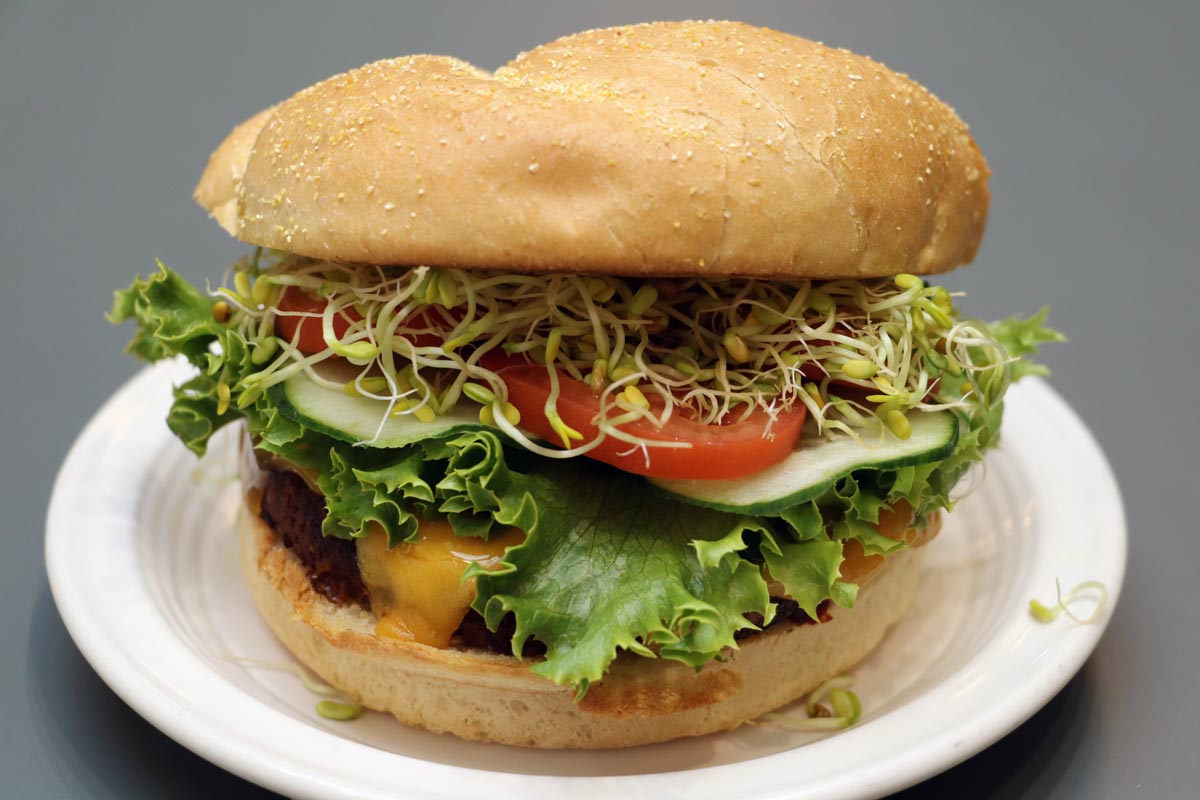 Veggie Burger, with cheese and vegetable toppings on a bun.