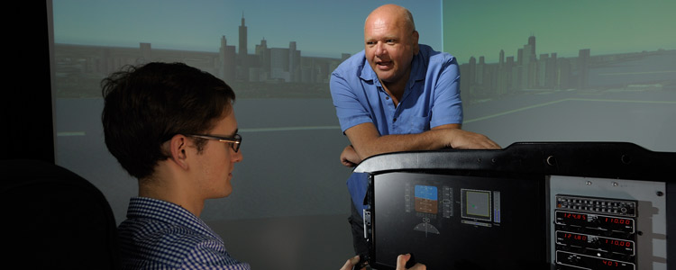 The flight simulator at the ISL supports several projects that are in constant pursuit of creating safer, more intuitive flying environments for pilots. Alex Kirlik engineers safe cyber-physical-human systems. With the help of graduate student Ben Seefeldt, Kirlik is finding better ways to display information to pilots so they can respond to emergencies more swiftly and accurately. The researchers are developing a feature on the control panel that dynamically provides information indicating a safe flying zone. If the plane is about to breach that safe zone, the pilot will be alerted and provided with information on how to remedy the situation.