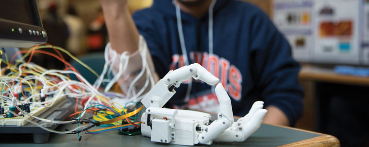 Aadeel Akhtar, a M.D./Ph.D. student, showcased his prosthetic hand device at the 2015 Beckman Institute Open House. The device incorporates sensory feedback, allowing users to sense the movement and pressure of the hand. With his start-up company PSYONIC, Akhtar is working to be able to distribute prosthetic hands around the world. Photo credit: Joyce Seay-Knoblauch, Illinois News Bureau
