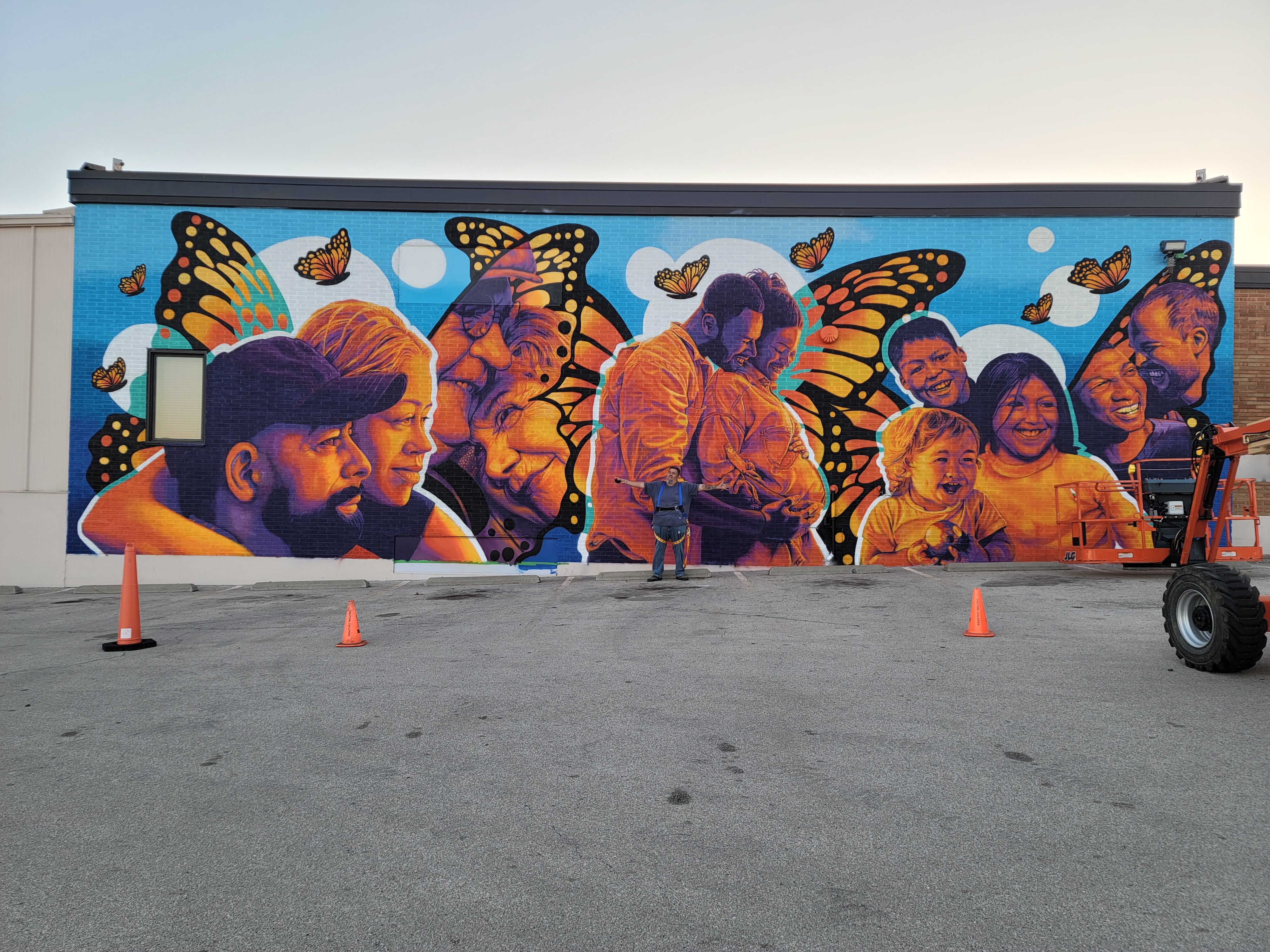 Jose Vazquez pictured with his full mural.