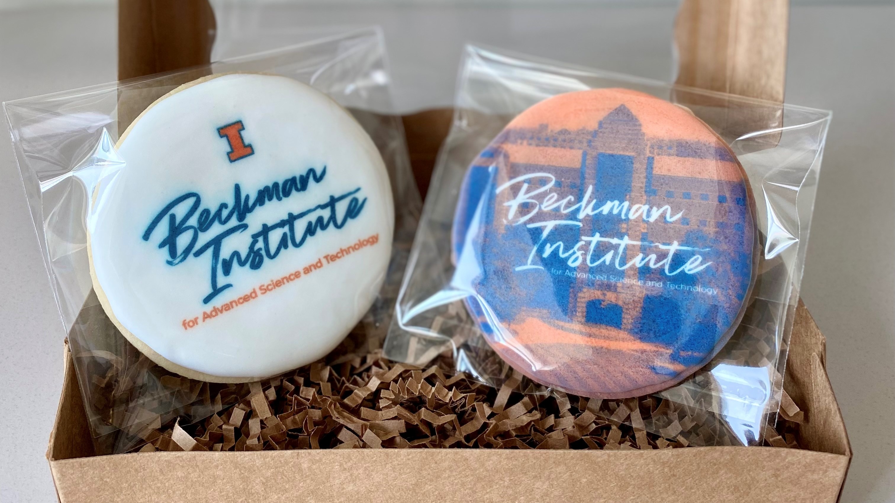 Two Beckman Institute branded cookies