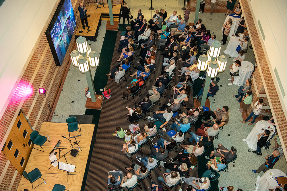 Beckman Director Jeff Moore addresses a crowd at the October 2019 performance of Quantum Rhapsodies at the Beckman Institute at the University of Illinois at Urbana-Champaign (UIUC)