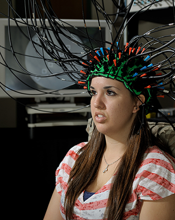 A student having her brain imaged using optical techniques