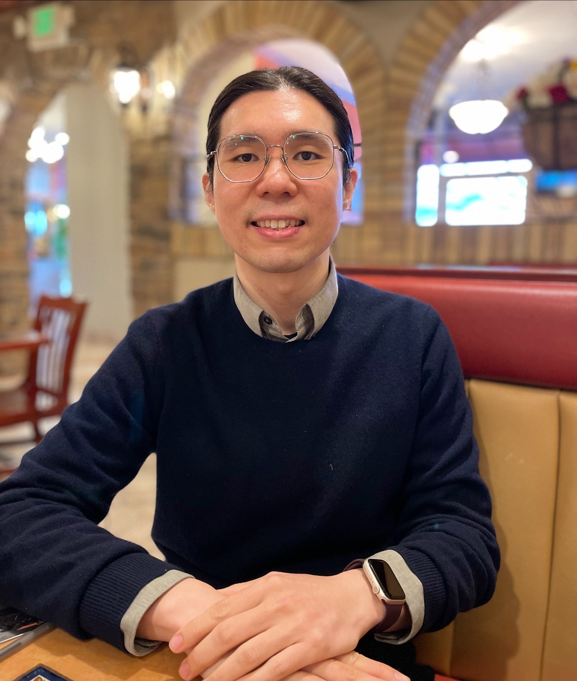 2024 Beckman-Brown Postdoctoral Fellow Hsi-Chun Chao sits at a table in a restaurant smiling.