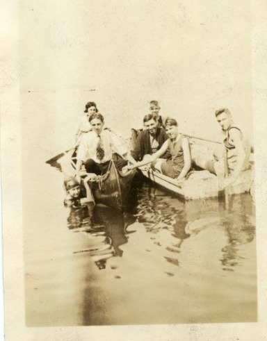 A yellowing photo of Mabel Beckman and friends canoeing near Brooklyn.