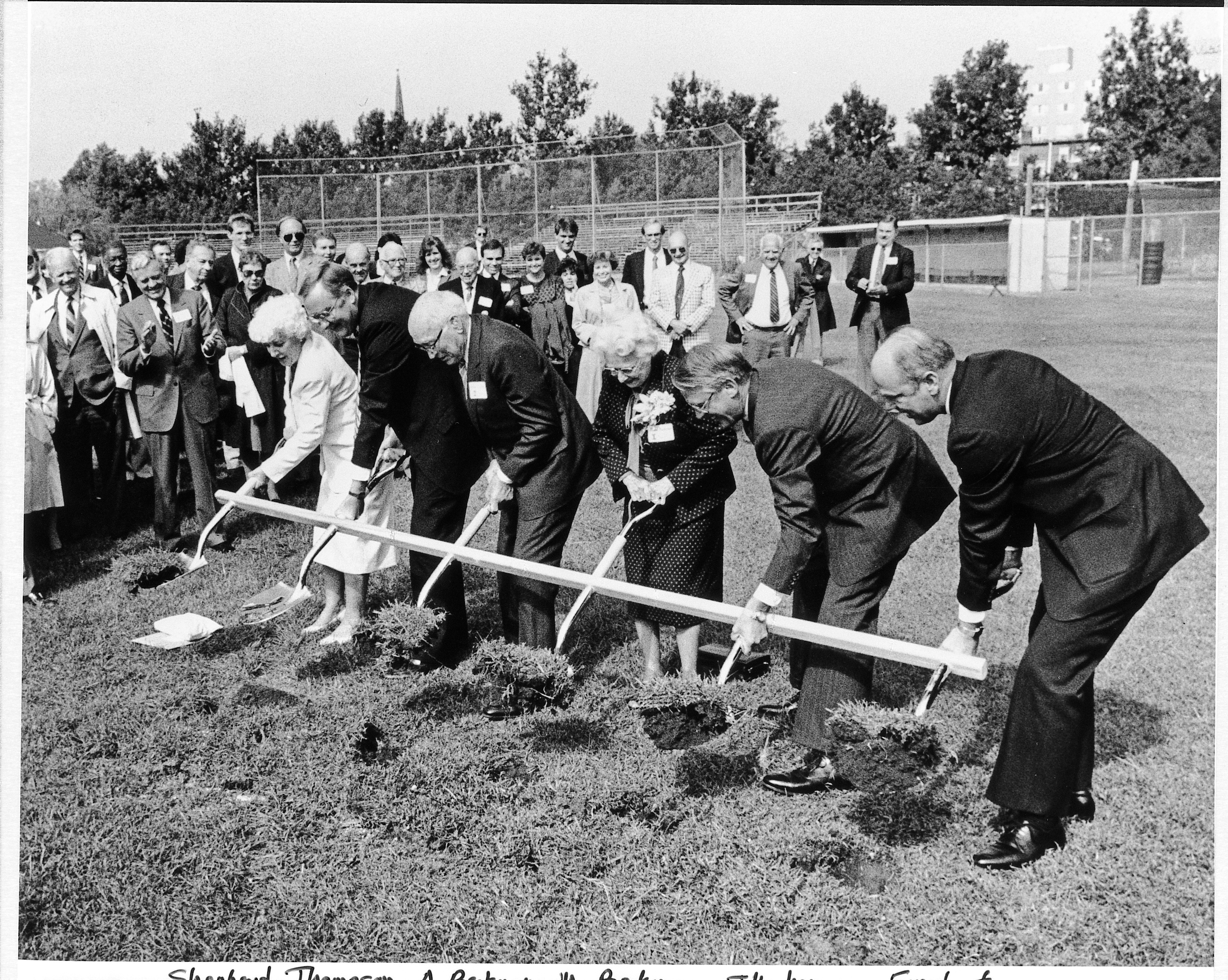 Mabel Beckman, Arnold Beckman, and others shovel a ceremonial scoop of soil at the Beckman Institute's groundbreaking ceremony.