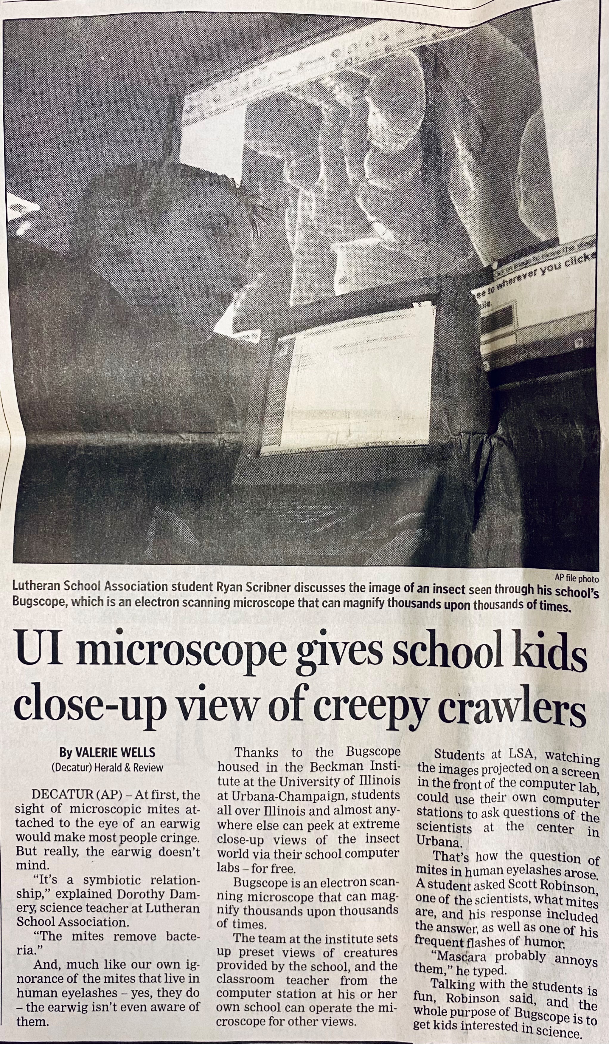 A newspaper clipping with the headline "UI microscope gives school kids close-up view of creepy crawlers" advertises a Bugscope session.