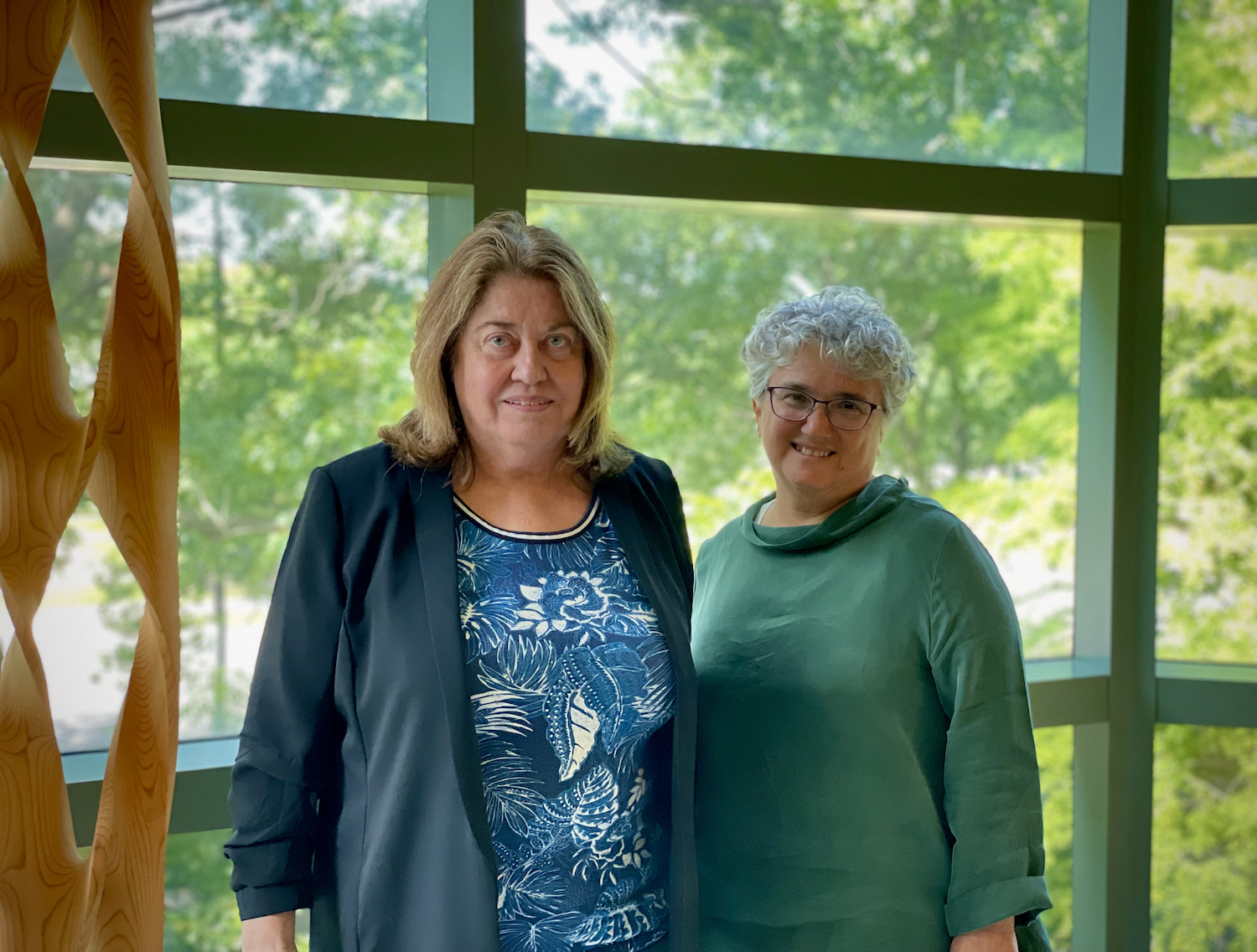 Monica Fabiani and Frini Karayanidis posing in front of a window at the Beckman Institute