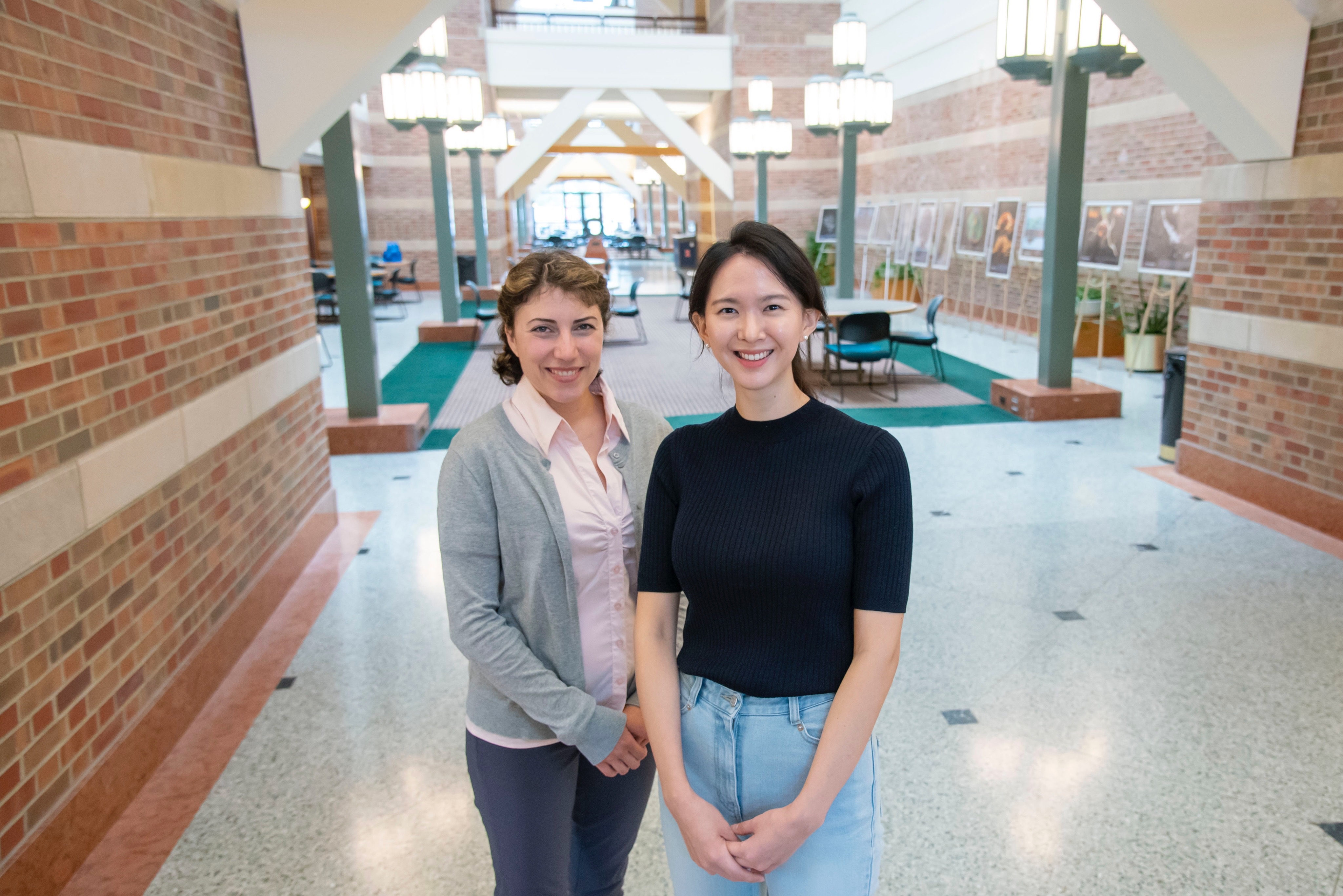 Sepideh Sadaghiani and Suhnyoung Jun stand side-by-side in the Beckman Atrium.