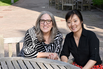 Researchers Liz Stine-Morrow and Xiaomei Liu are shown on the Beckman patio