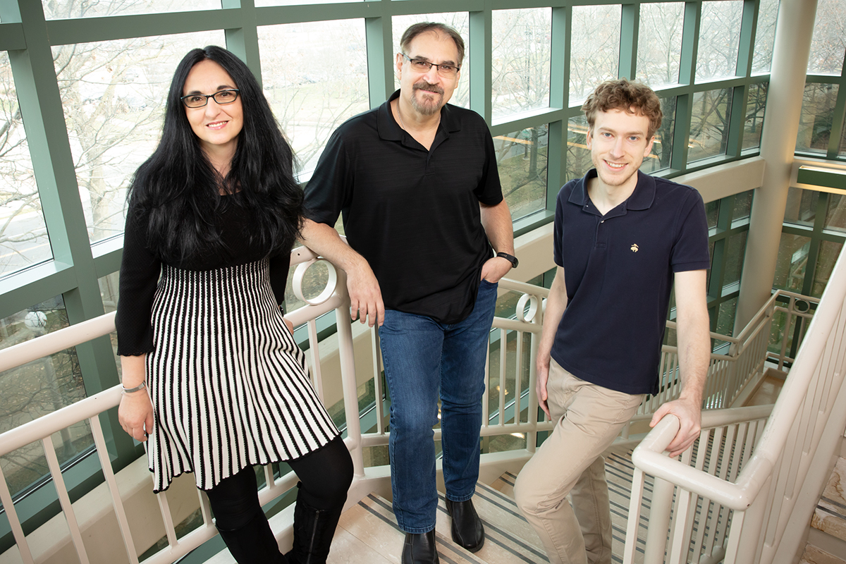 Paul Bogdan, Florin Dolcos, and Sanda Dolcos pictured on a staircase in the Beckman Institute.