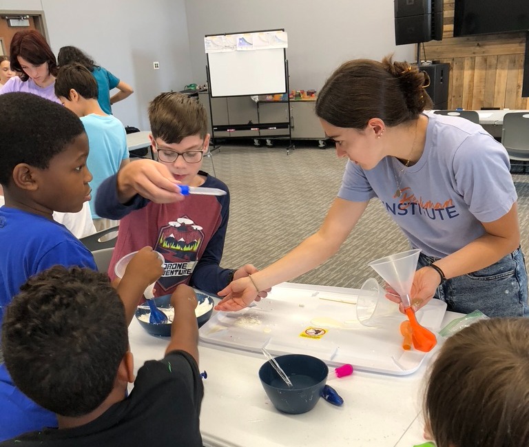 Nicole Godellas facilitates an outreach activity with students.