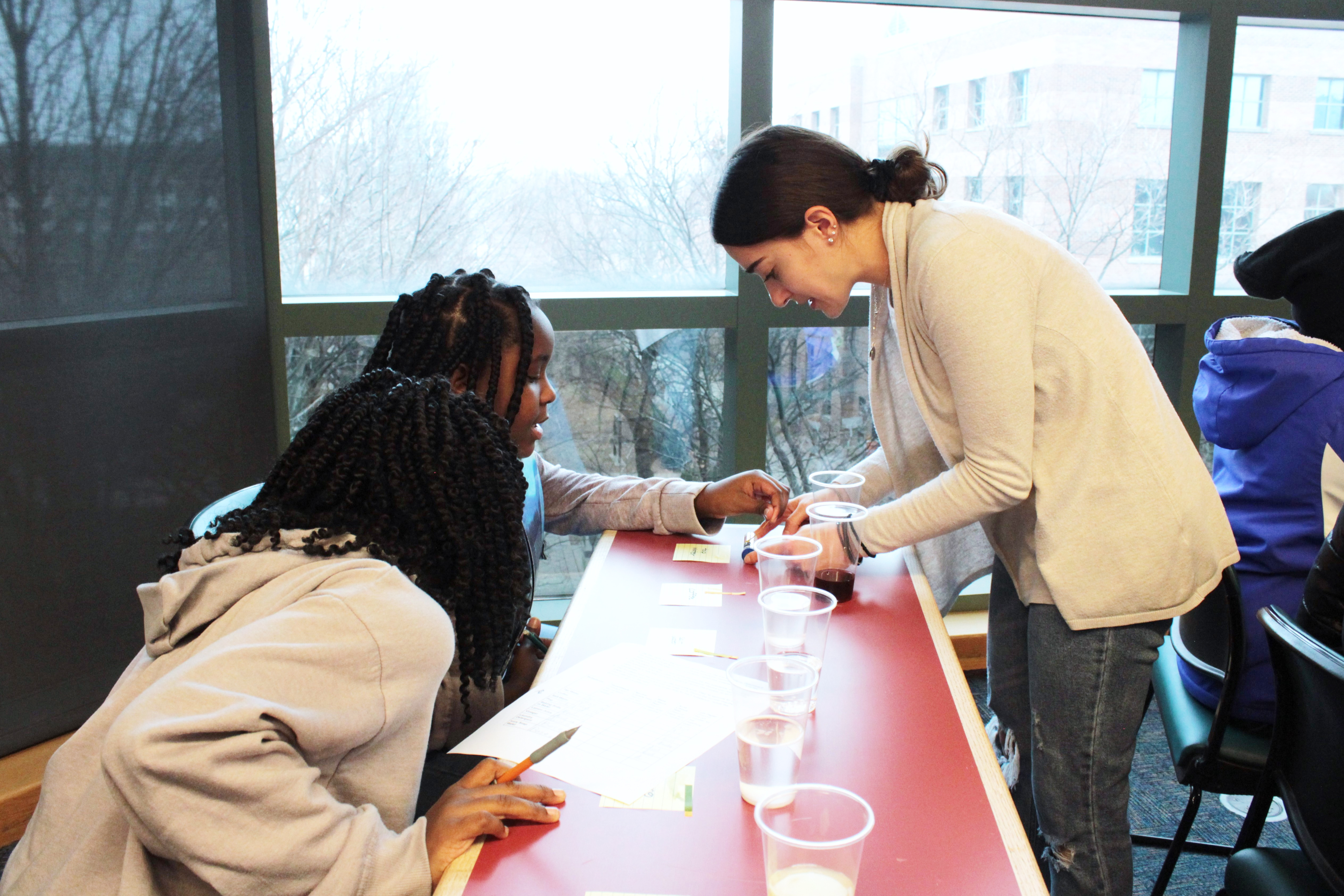 Nicole Godellas leading an outreach session with Franklin STEM Academy middle-school students.