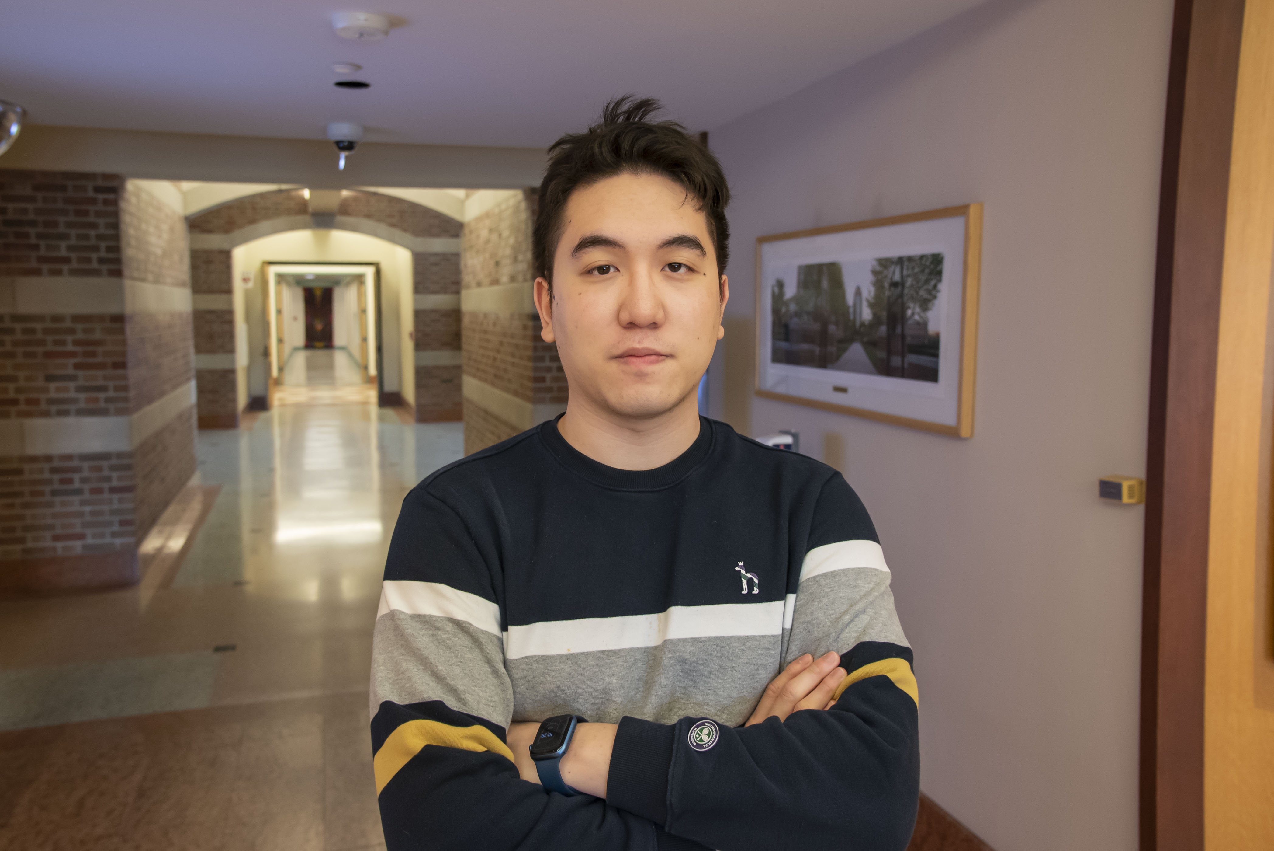 An environmental portrait of Zepeng Wang in the Beckman Rotunda.