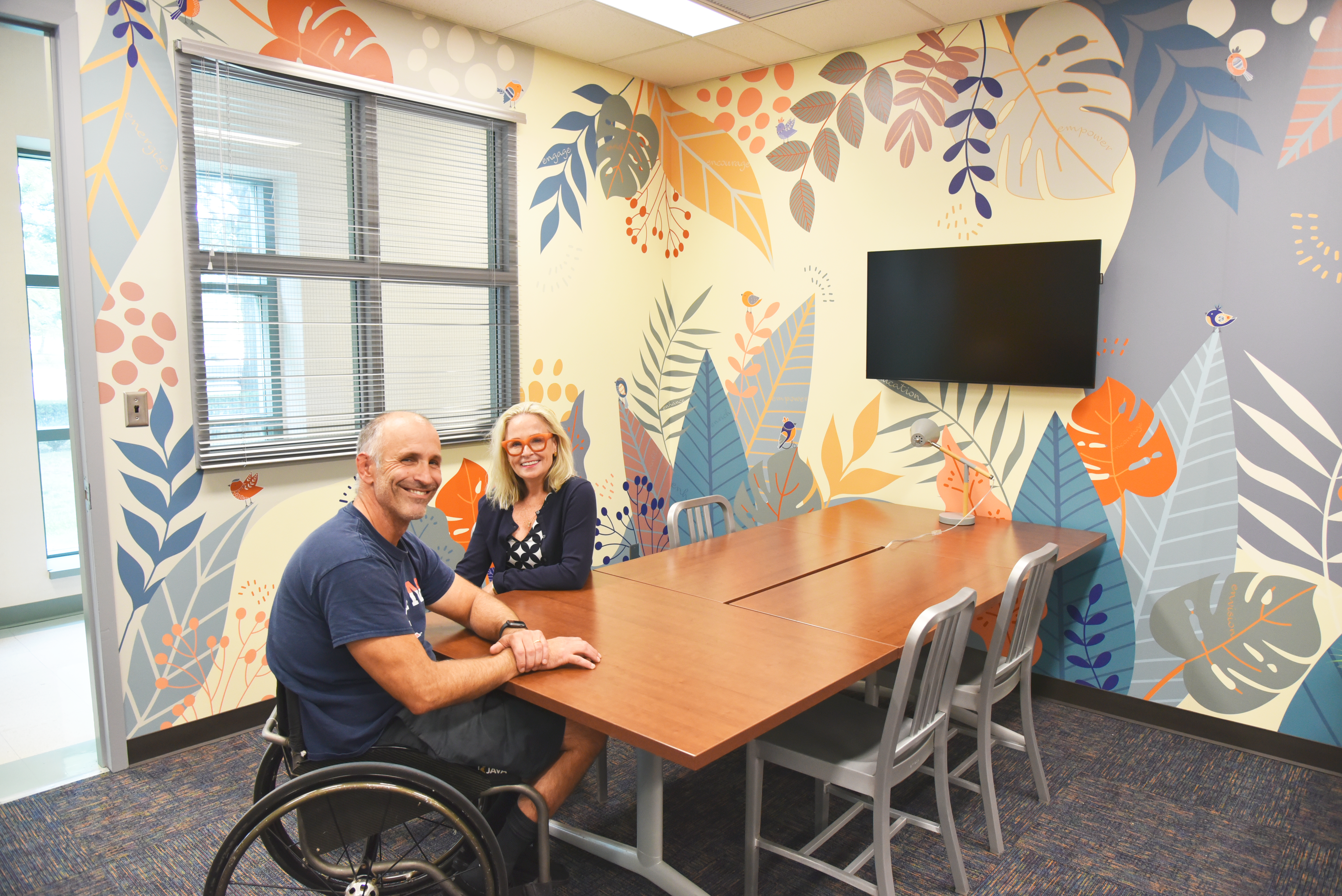 Adam Bleakney and Deana McDonagh sit at a conference table in the (dis)Ability Design Studio.