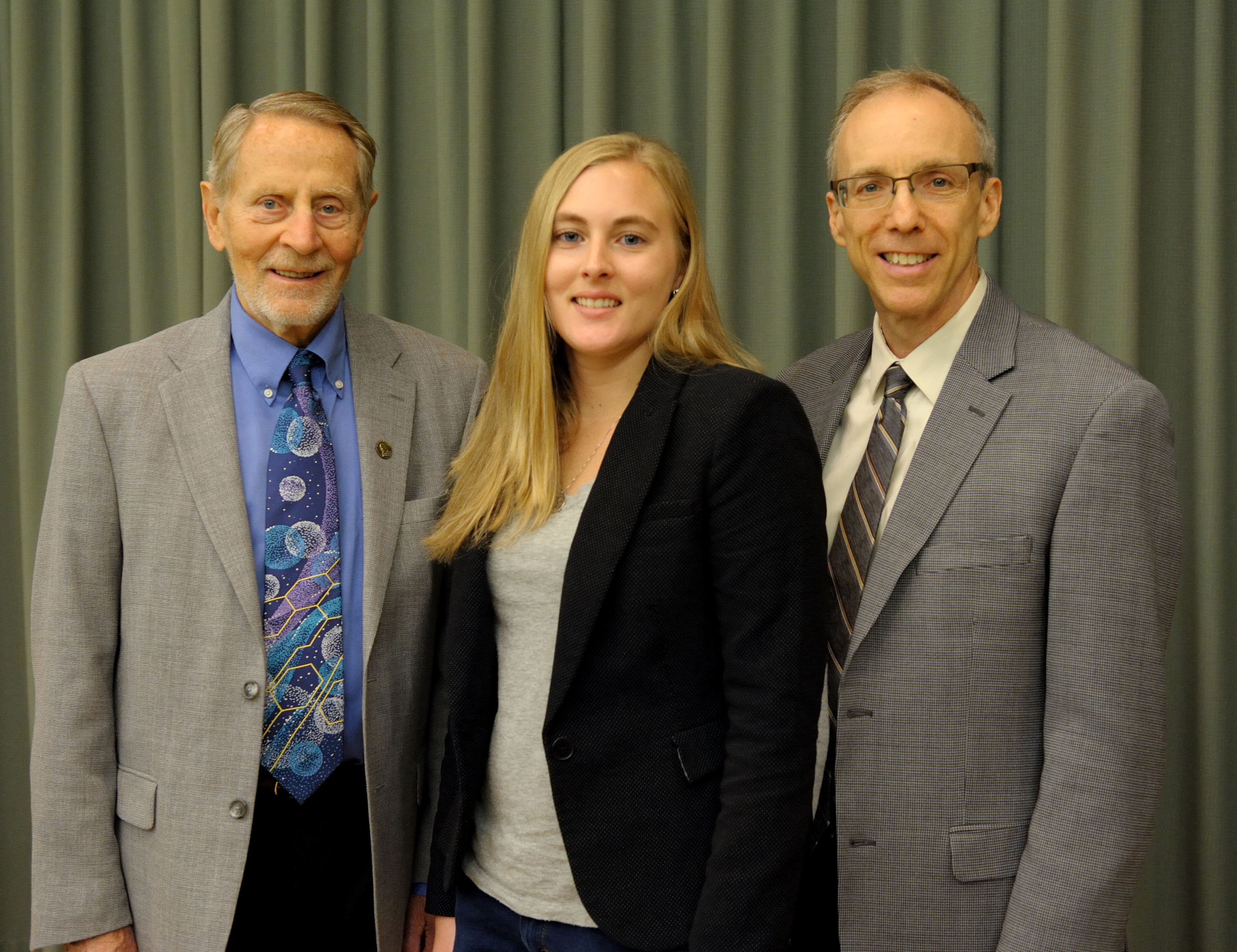 Lydia Kisley poses between Ted Brown and Jeff Moore.