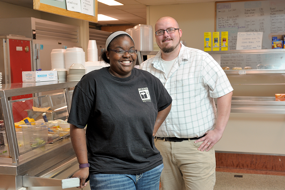 Juanisha Hutchison and Josh Walker pose in the Beckman Cafe at the Beckman Institute at the University of Illinois at Urbana-Champaign (UIUC)