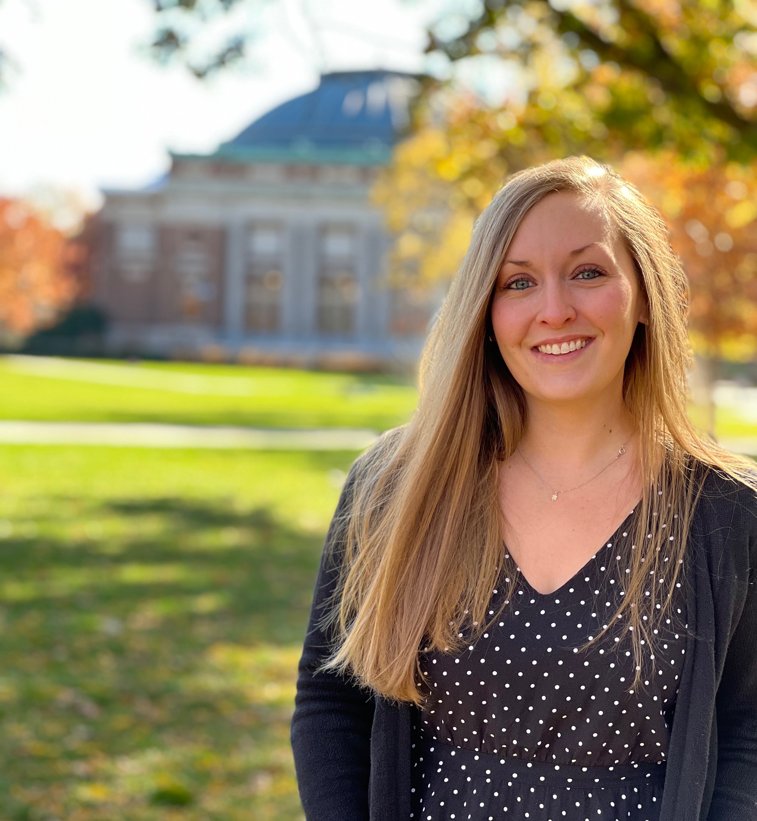 A headshot of Haley Skymba, who is standing on the University of Illinois Main Quad with the Union blurred in the background.