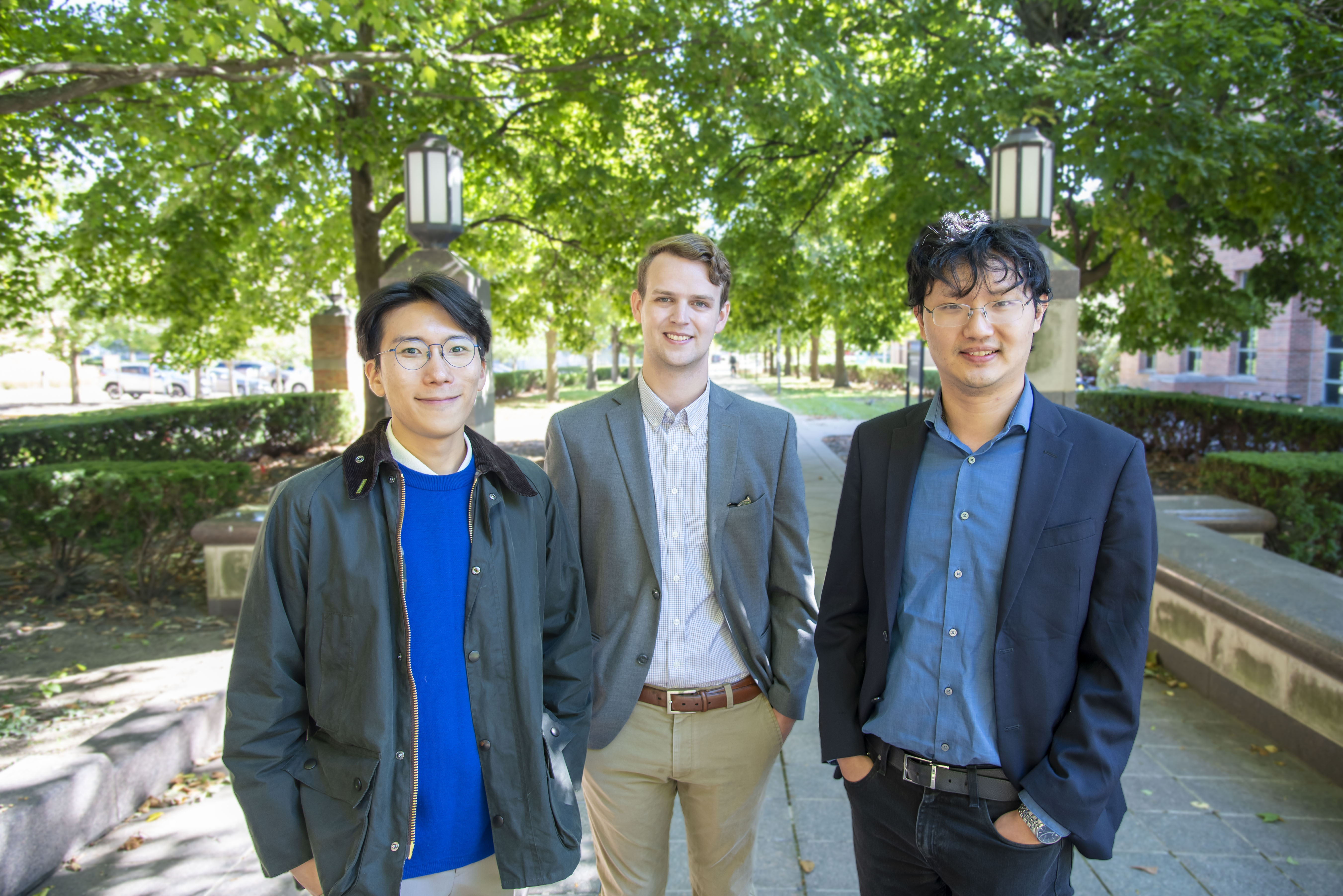 Jemin Jeon, Stephen Cotty, Xiao Su standing on the path outside the Beckman Institute