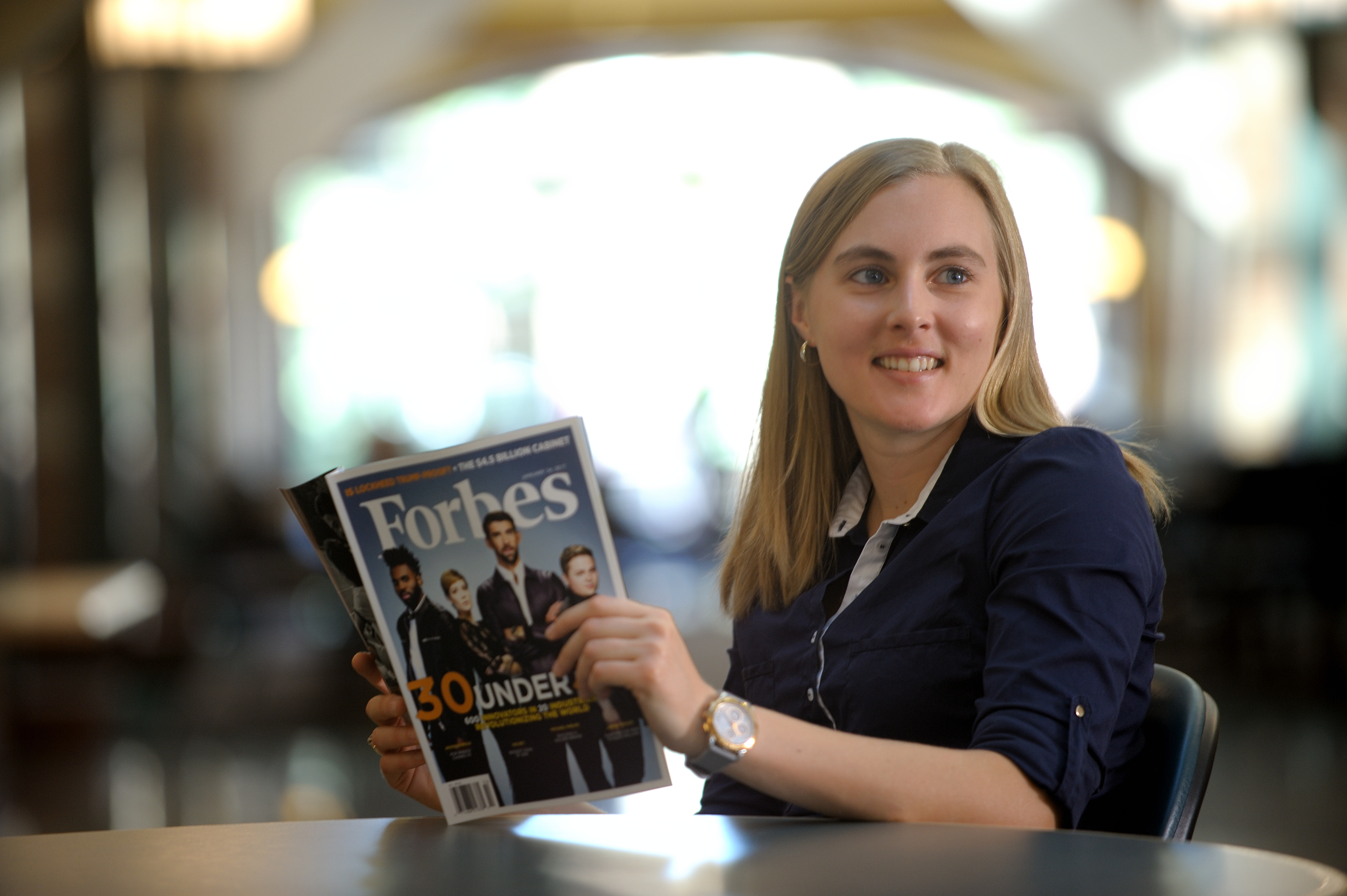 Lydia Kisley holds a copy of the Forbes Magazine 30 Under 30 issue.