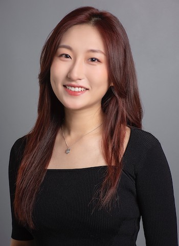 Xiaomei Li, a smiling woman with long red-brown hair and a black shirt.