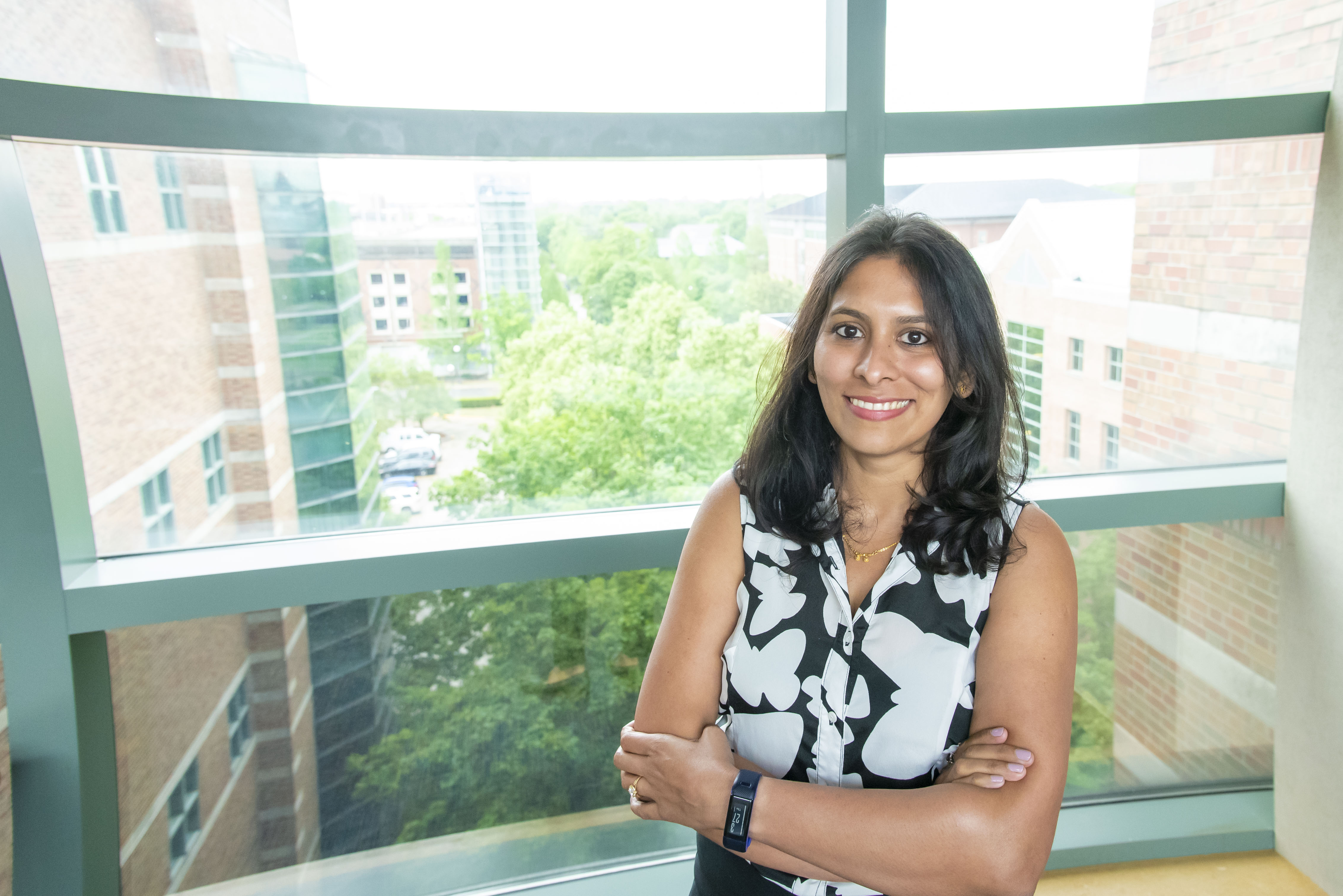 Yamuna Phal leans against a window at the Beckman Institute.