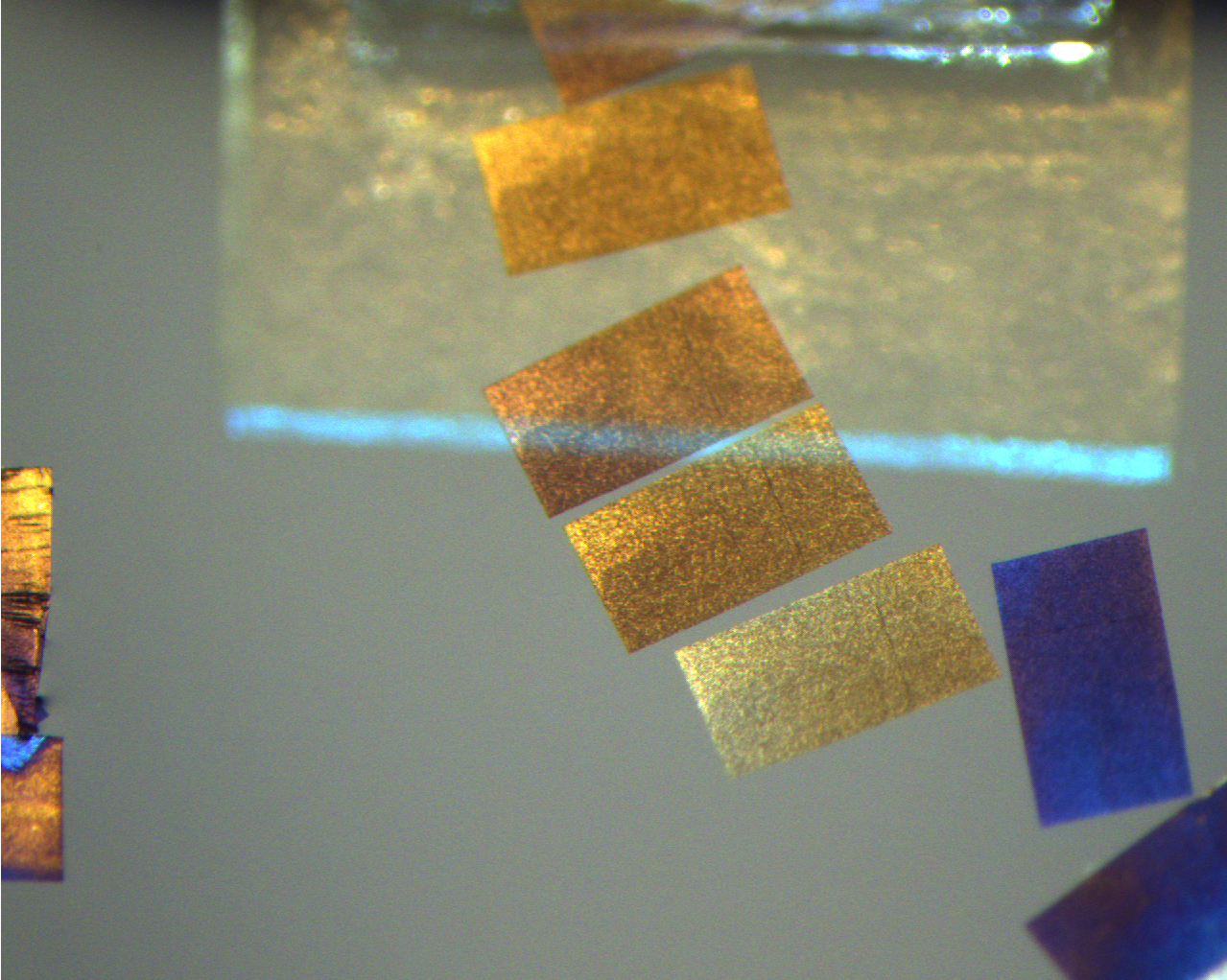 Ultrathin sections of a polymer composite material floated on water.
