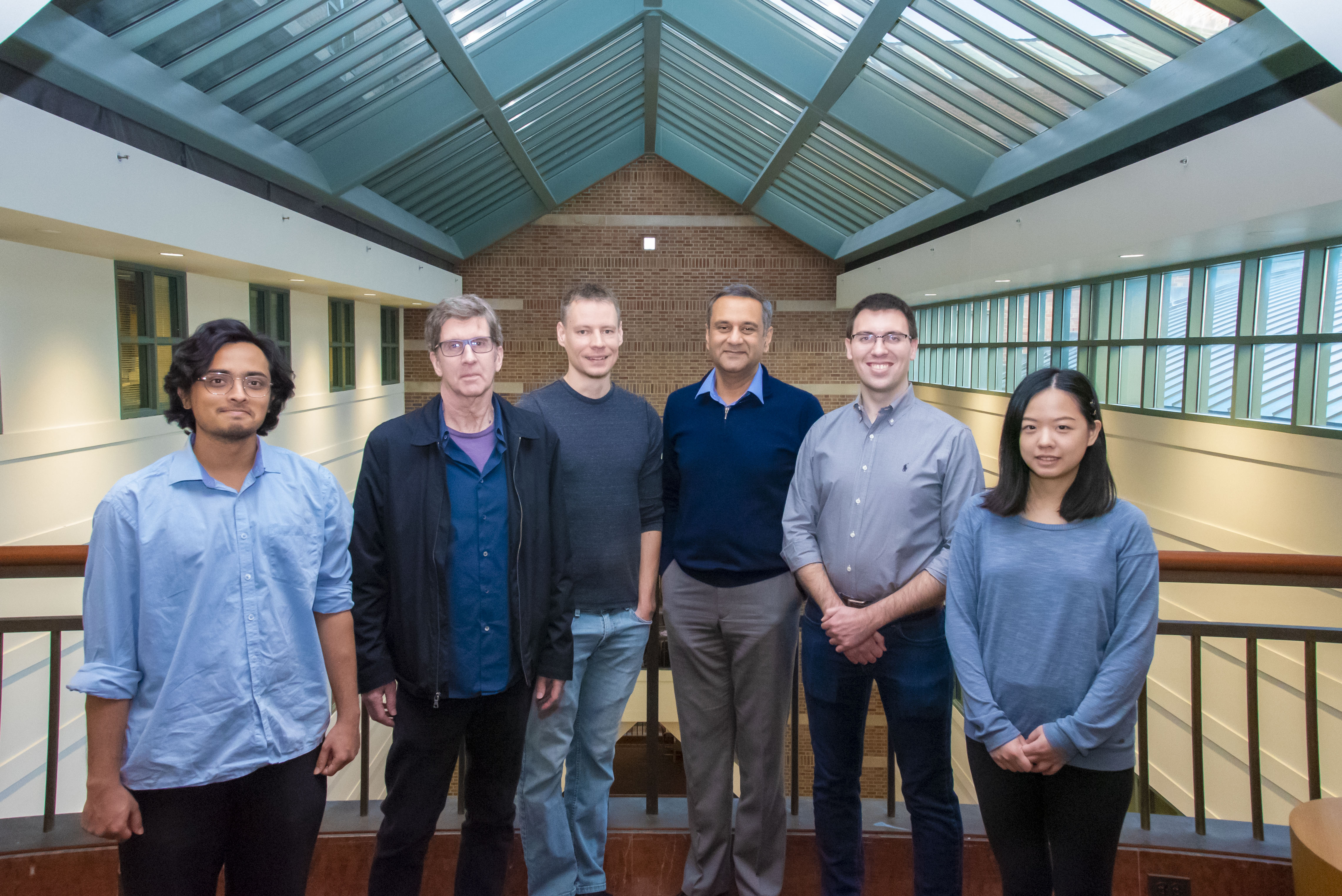 Members of Rohit Bhargava's lab group pose for a group photo on one of Beckman's famous bridges.