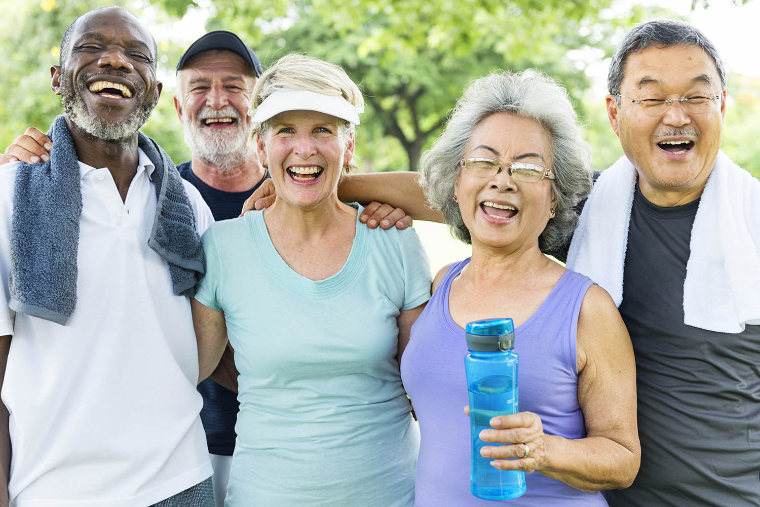 A group of older adults dressed in workout gear pose for the camera